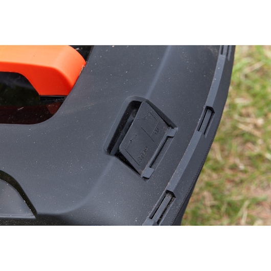 BLACKDECKER BCMW33362L1 lawn mower control panel close-up with STOP and GO buttons visible.