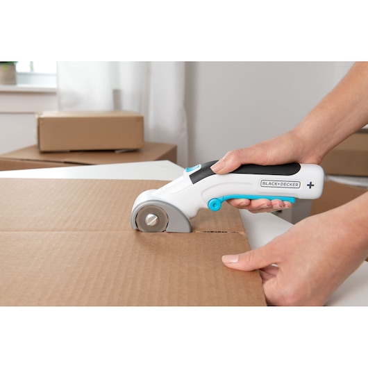 Photo of BLACKDECKER BCRC115 electric box cutter used to open cardboard box.