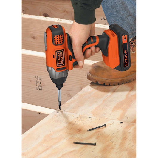 BLACKDECKER BDCIM18N impact driver used to drive screw into plywood during construction.