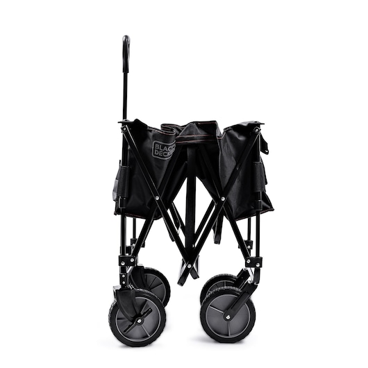 A BLACK+DECKER collapsible utility wagon, shown in a folded position with four large wheels and a sturdy metal frame, suitable for transporting items.