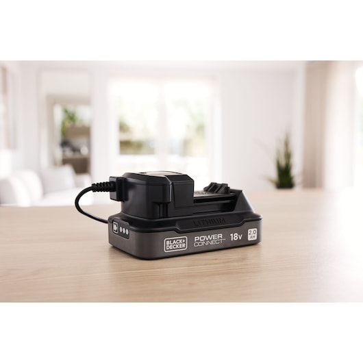 BLACK+DECKER BDL2018S1B lithium 18V 2.0Ah battery with charger on table, product side view.