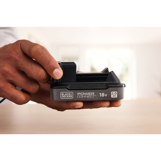 BLACK+DECKER 18V 2.0Ah lithium battery BDL2018S1B held in hand, POWER CONNECT label visible.
