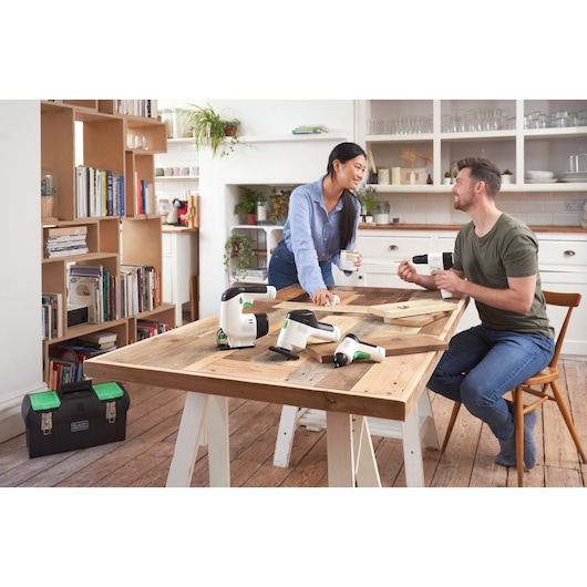 Photo of BLACKDECKER BDST60120 power tools on a wooden table in a bright kitchen, with toolbox on floor.
