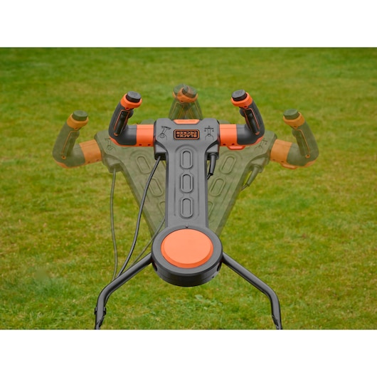 BLACKDECKER BEMW481ES lawn mower adjustable handle in black and orange on grass, closeup photography.