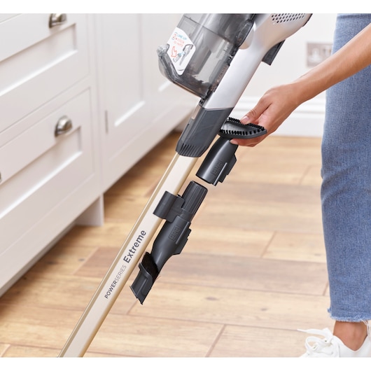 BLACKDECKER BHFEV36B2D cordless vacuum cleaner with accessory attachment in a kitchen setting, side angle.