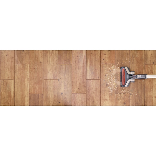 BLACKDECKER BHFEV36B2D stick vacuum cleaning debris on wooden floor, top view, product category Photography.