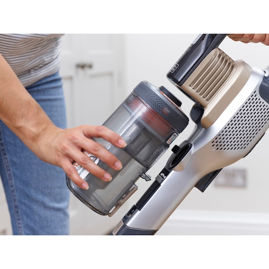 Photo of BLACKDECKER BHFEV36B2D vacuum cleaner with removable dust container being handled.