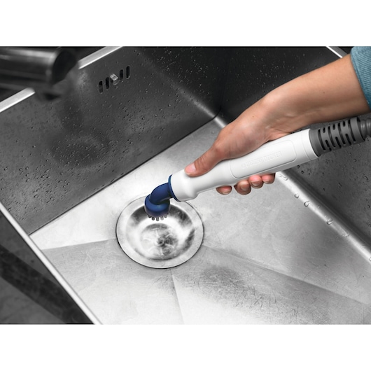 BLACKDECKER BHSM1610DSM handheld cleaning tool scrubbing a stainless steel sink drain.