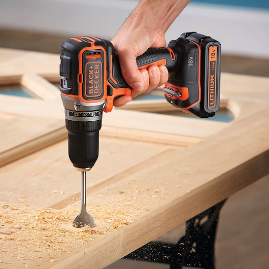 BLACKDECKER BL186N cordless drill with 18V lithium battery drilling wood in workshop.