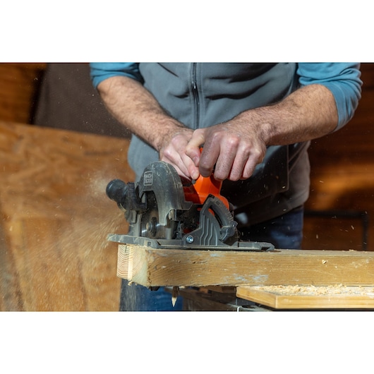 BLACKDECKER BLCCS78N circular saw in use cutting wood, close-up action shot.