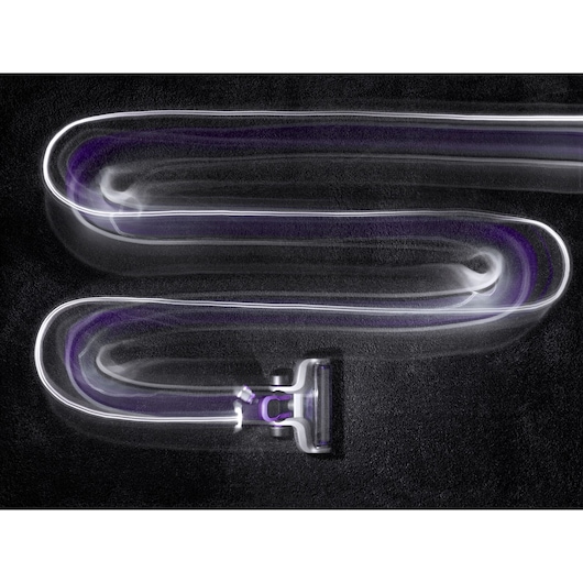BLACKDECKER cordless stick vacuum CUA525BHP in motion, leaving light trails on black carpet, top view.